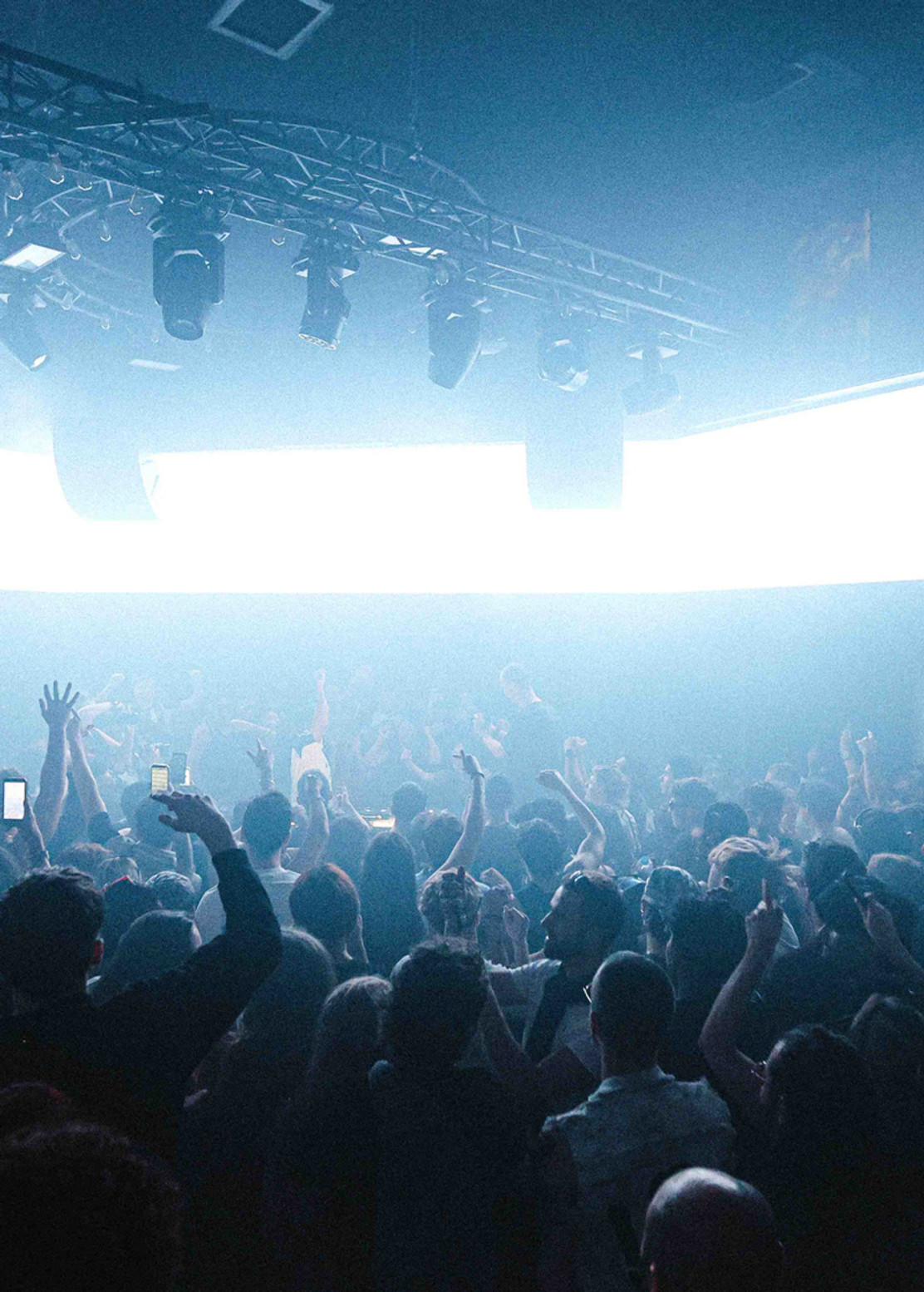 Club crowd under production lighting