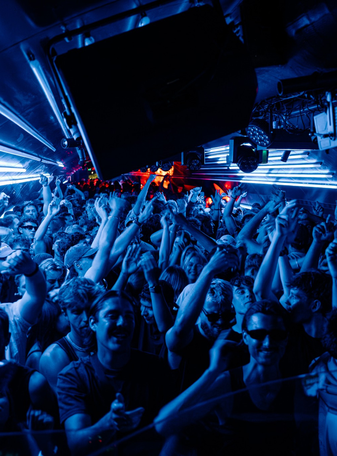 Blue-lit crowd at a Kinetix club night
